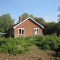 the existing bungalow prior to demolition and clearance of the site for a new low energy house